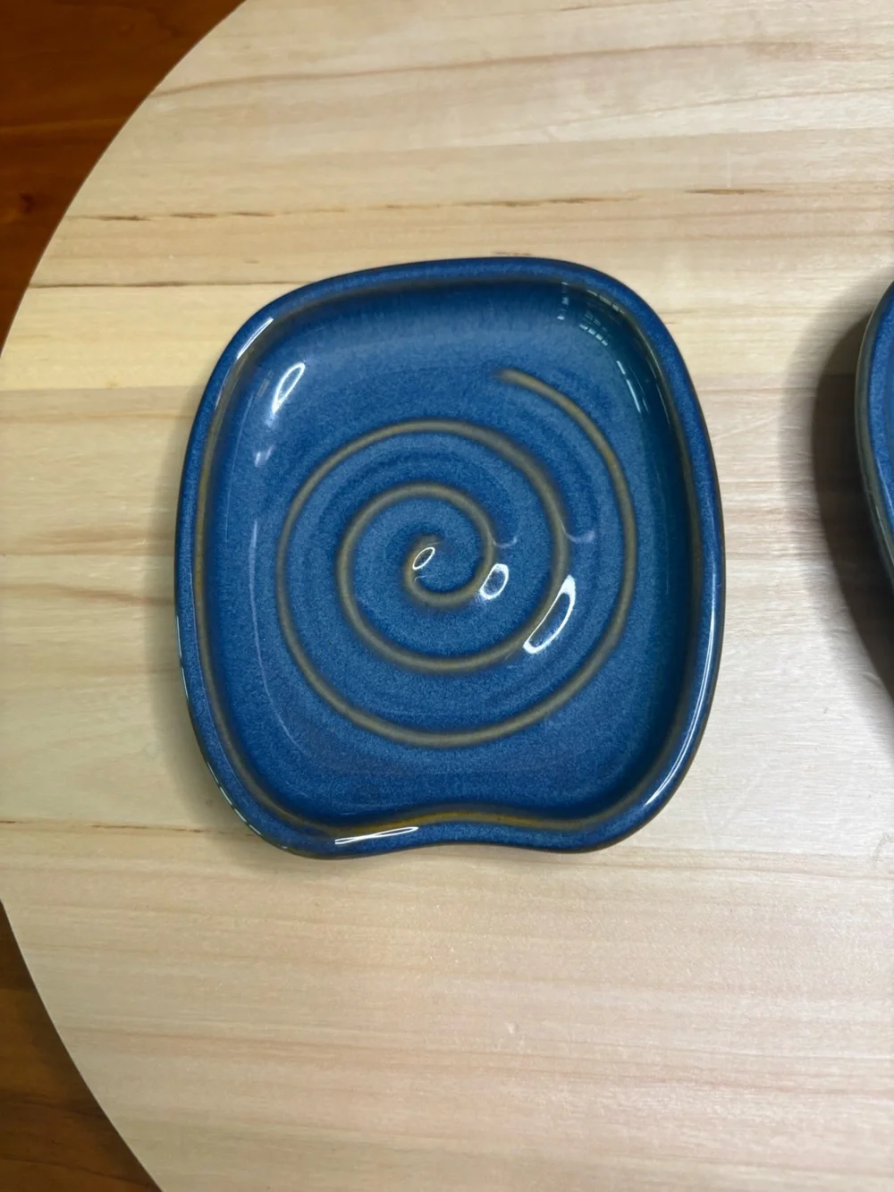 Pampered Chef Nesting Spoon Rest Set featuring a blue glaze with a swirl design.